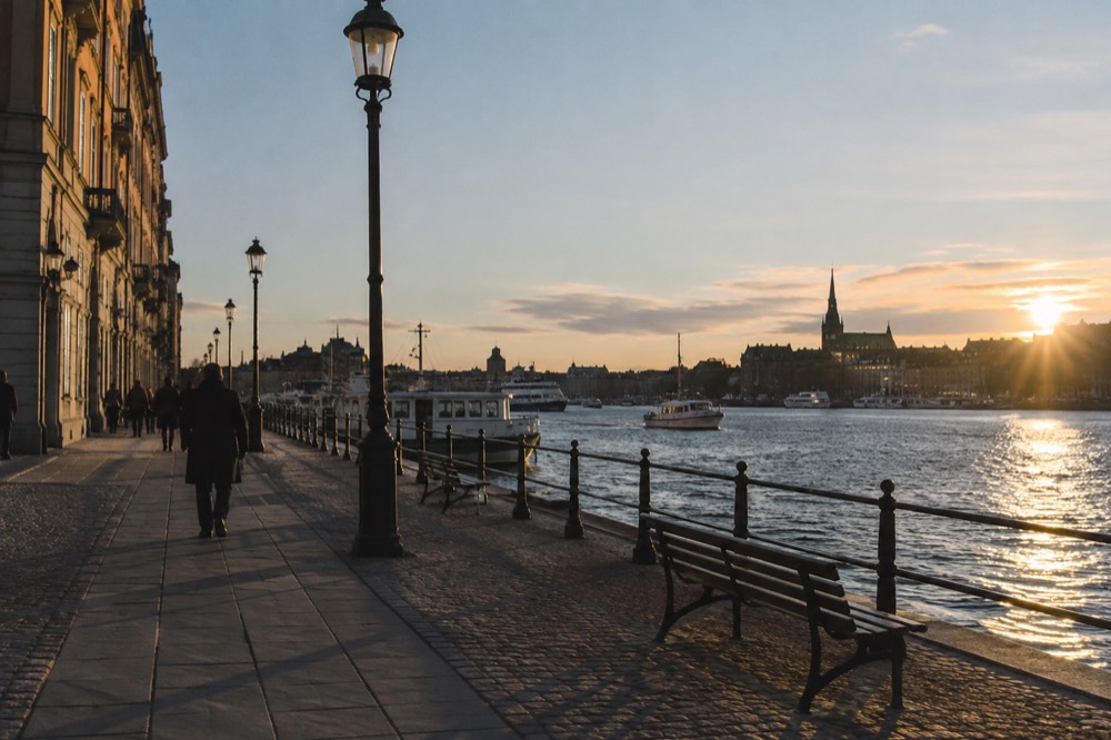 City waterfront in warm evening light with long shadows