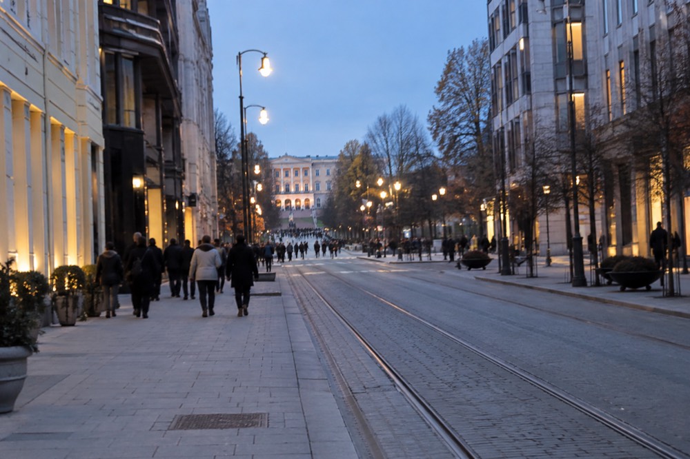 Oslo's main street lined with Norwegian flags on a bright spring day