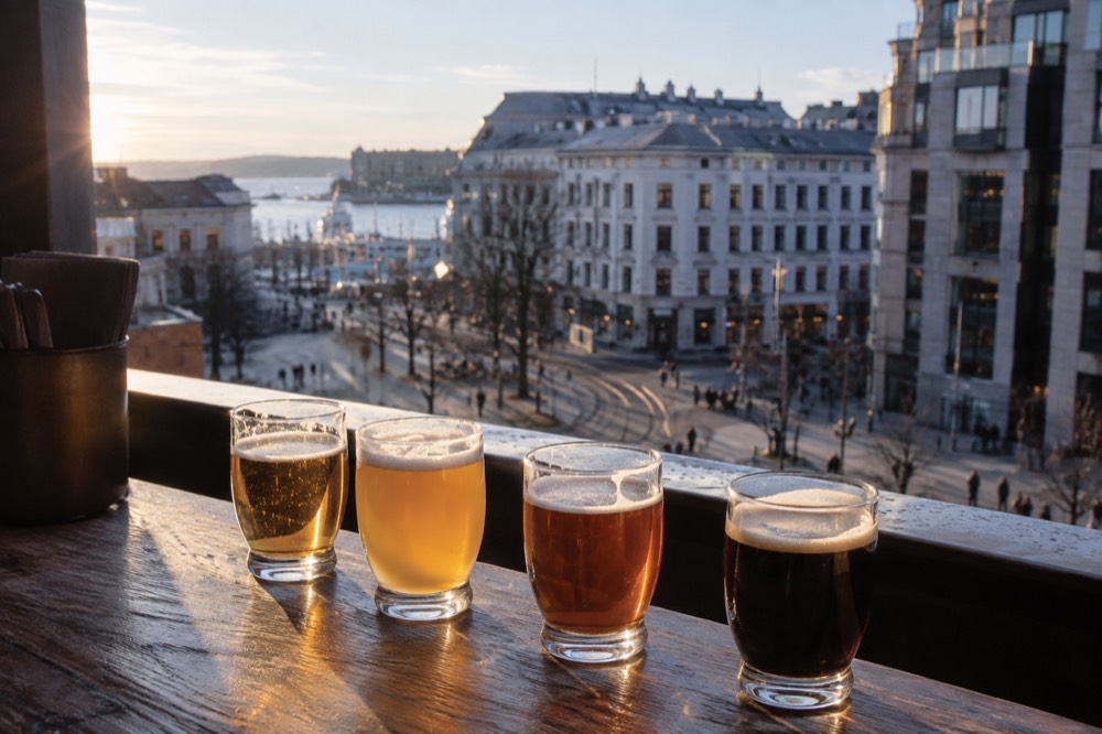 Tasting glasses of different colored beers lined up on a wooden bar top