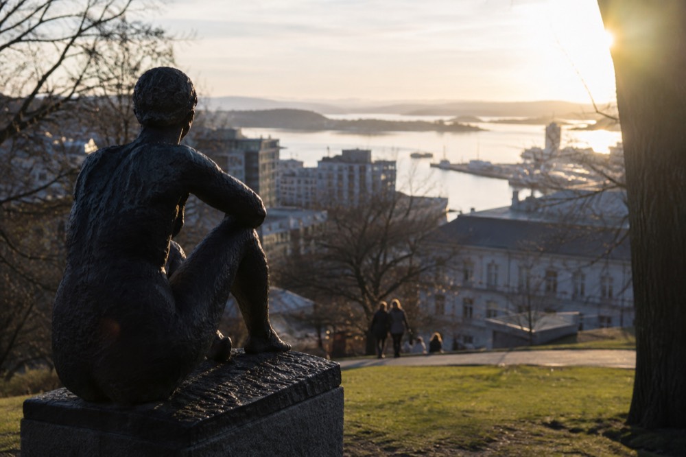 Sculptures on a green hillside overlooking the Oslo harbor