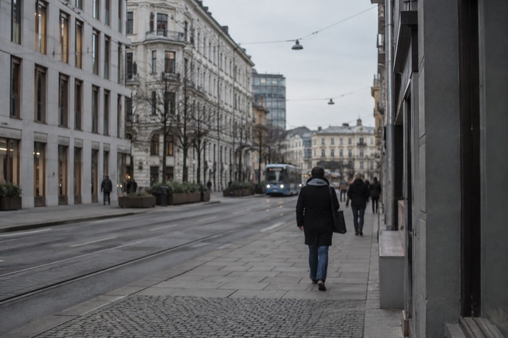 A street scene in central Oslo with Norwegian signage above shop fronts