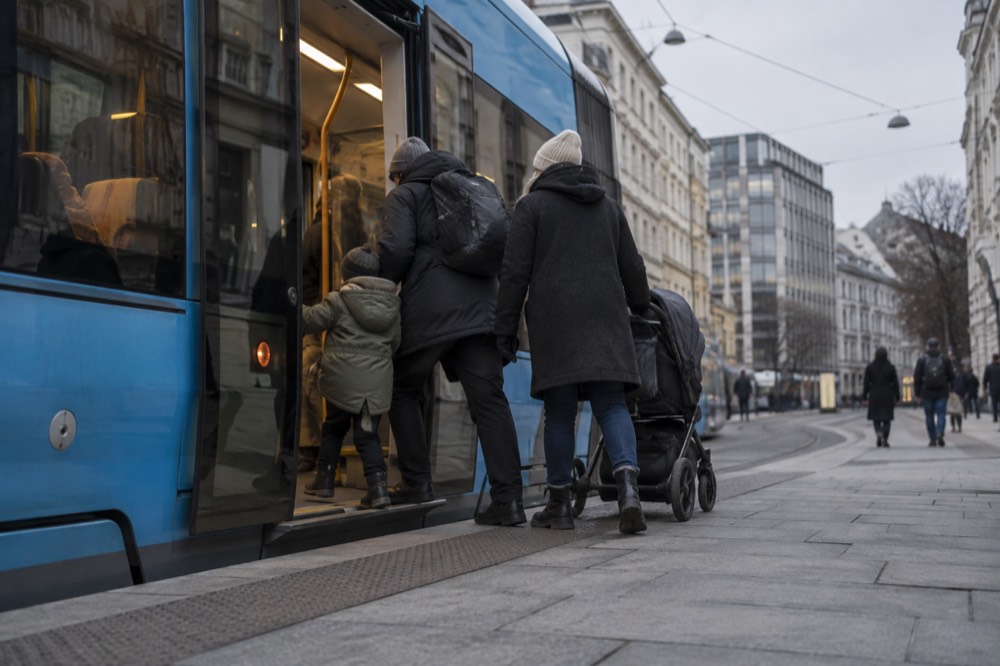 A family boarding a low-floor tram in central Oslo