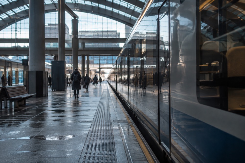 Long-distance train waiting at a platform inside a modern station hall