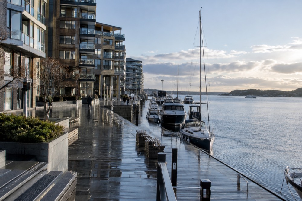 Aker Brygge waterfront with moored boats and apartment buildings along the Oslofjord