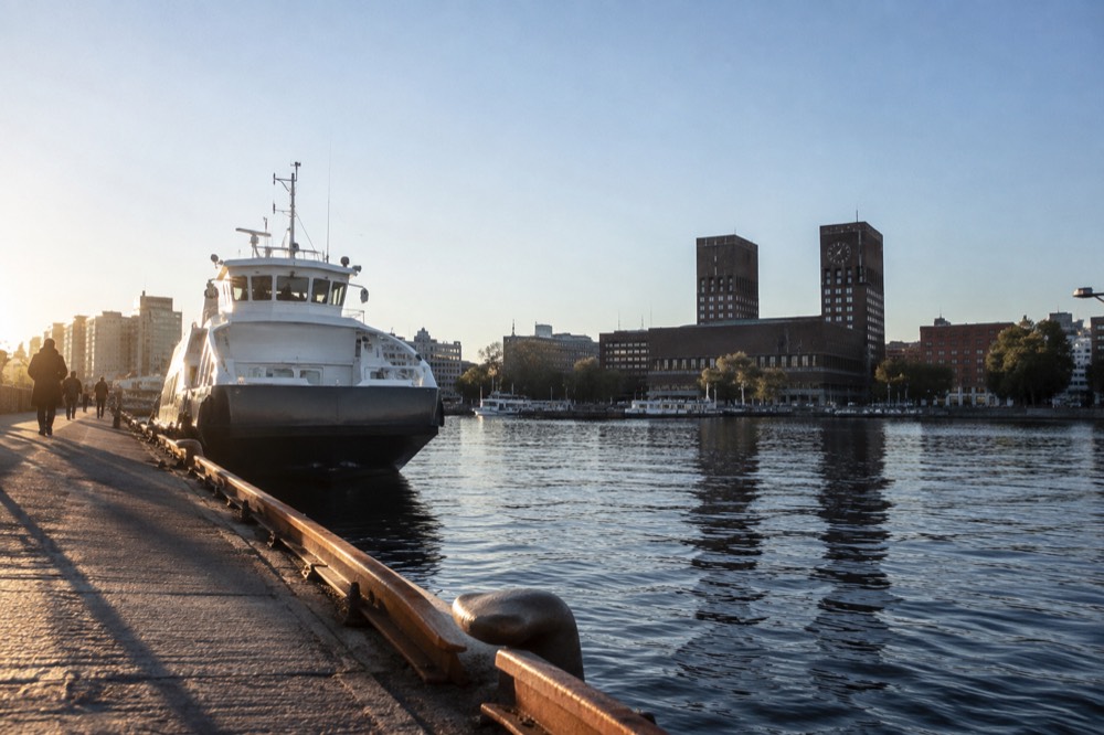 Ferry at an Oslo pier with the city hall behind it