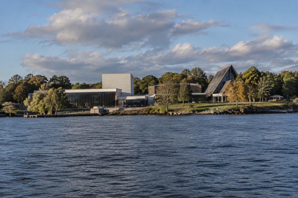 Museum buildings on the Bygdøy peninsula seen from the water on a calm day