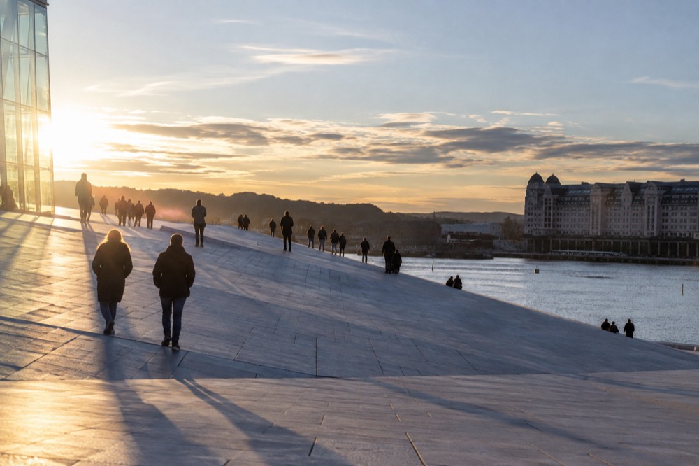 People walking on the sloping marble roof of the Oslo opera house