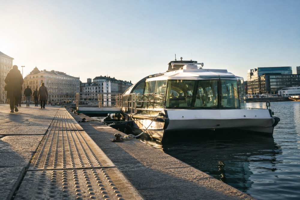 Electric sightseeing boat at a central Oslo pier with level boarding ramp