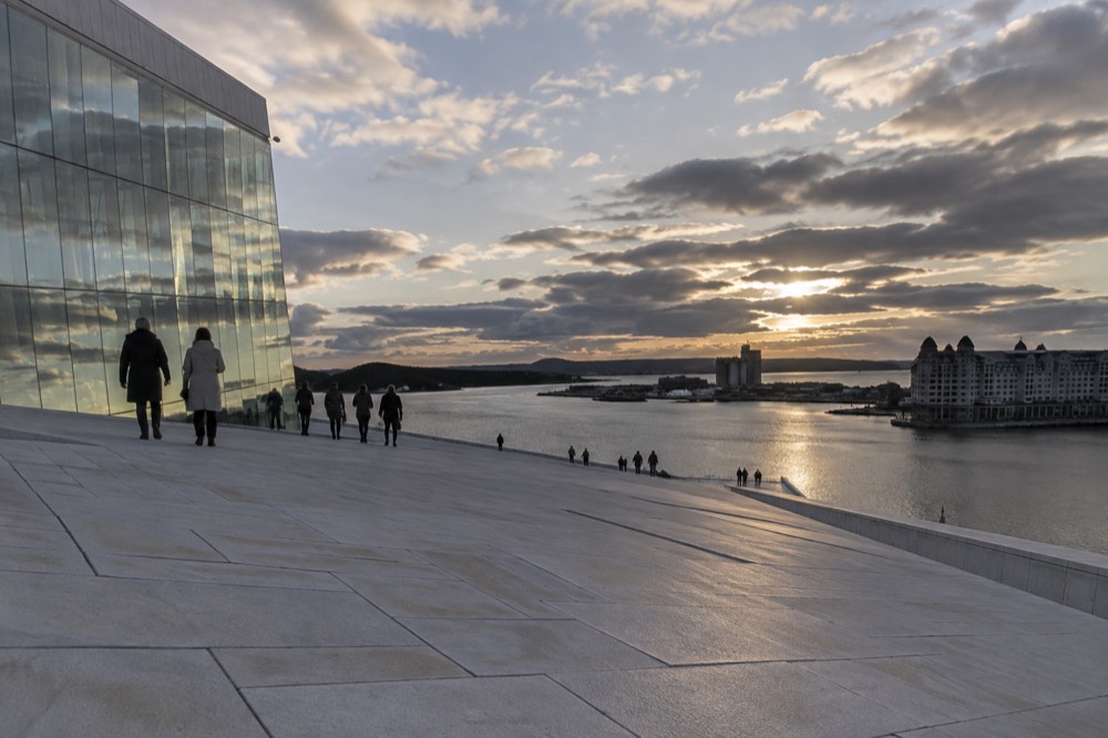 Gentle sloping marble ramp of the Oslo Opera House roof at dusk