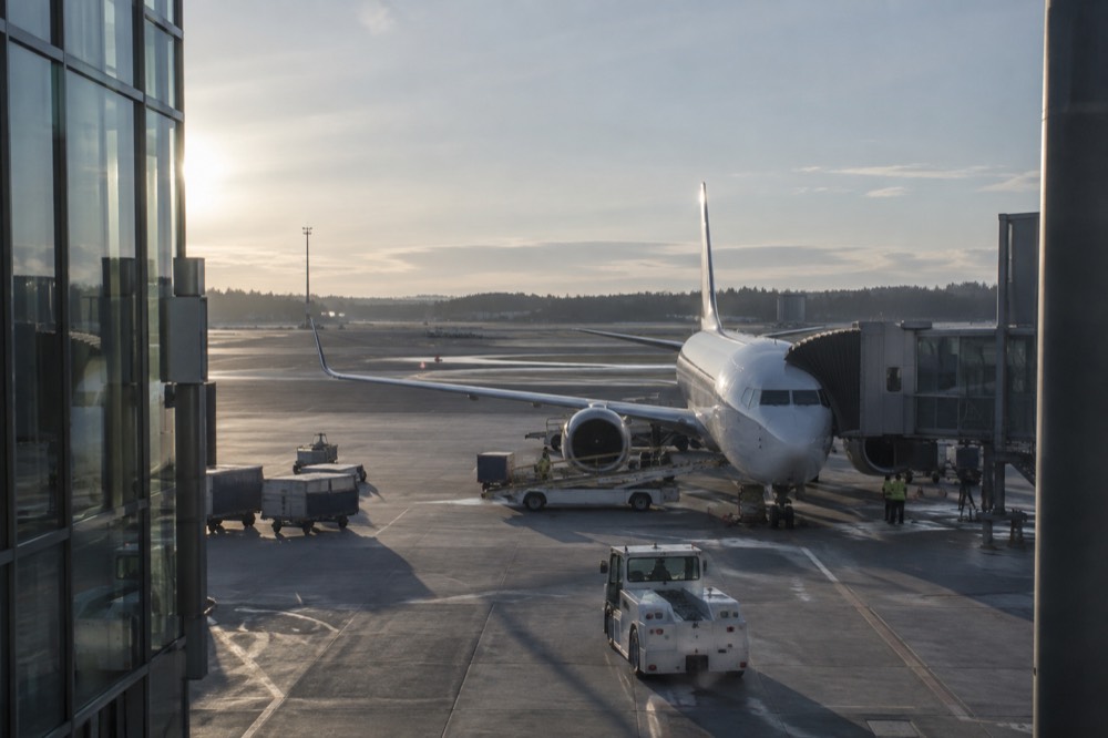 Regional airport building exterior with a low-cost aircraft at a gate