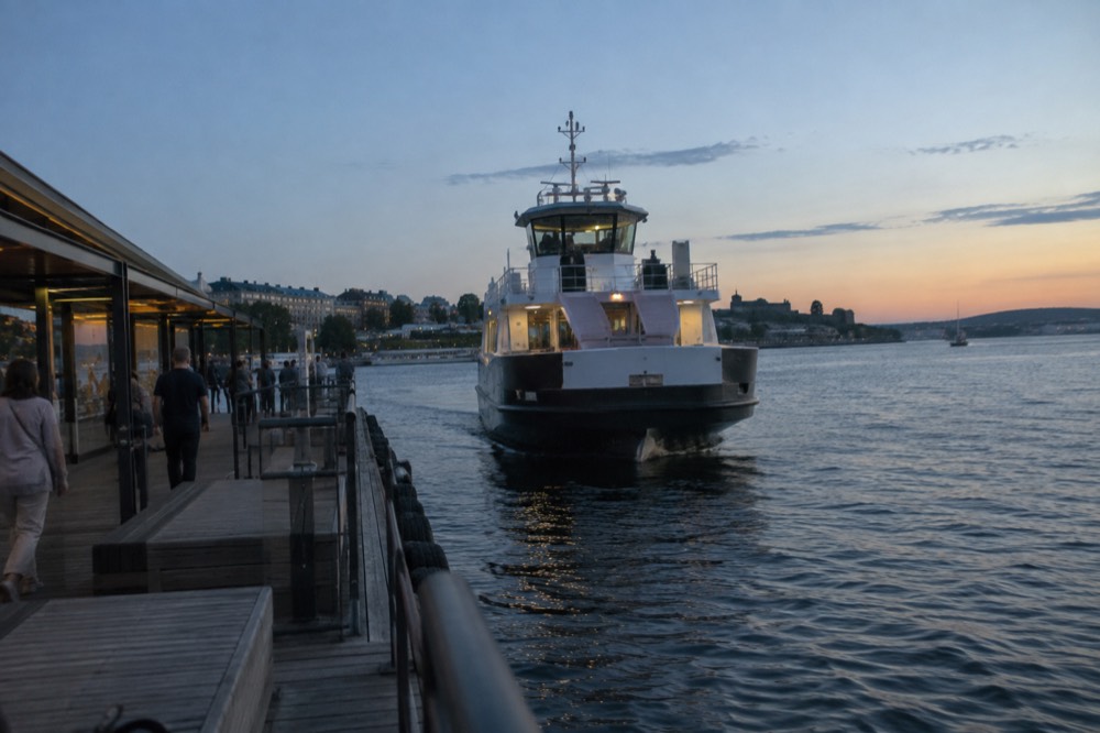 A public ferry at a wooden pier in the Oslo harbor on a summer day