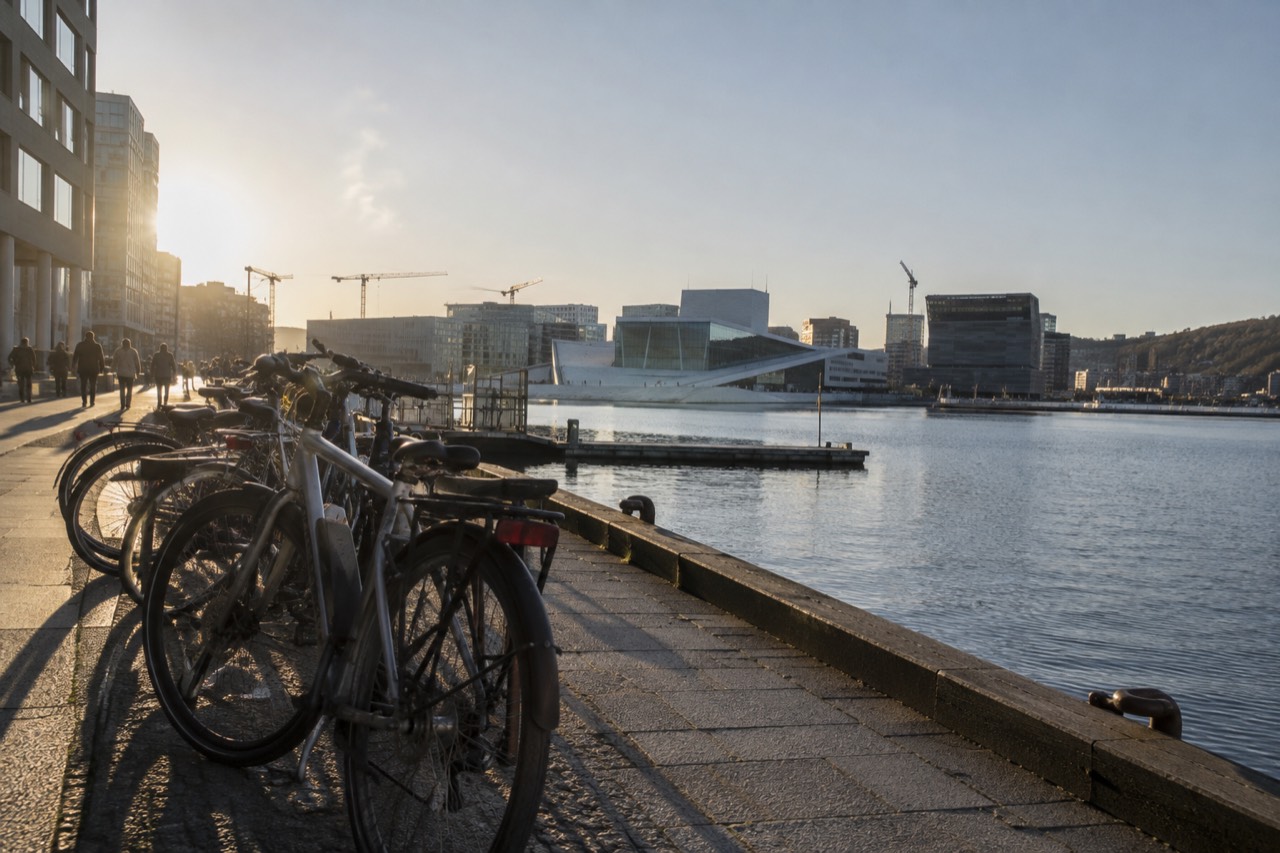 Bicycles parked in a row along a waterfront promenade in Oslo