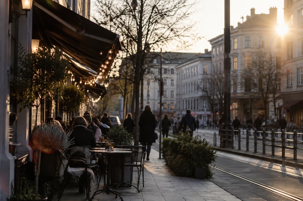 A café-lined street in Grünerløkka with outdoor tables and string lights