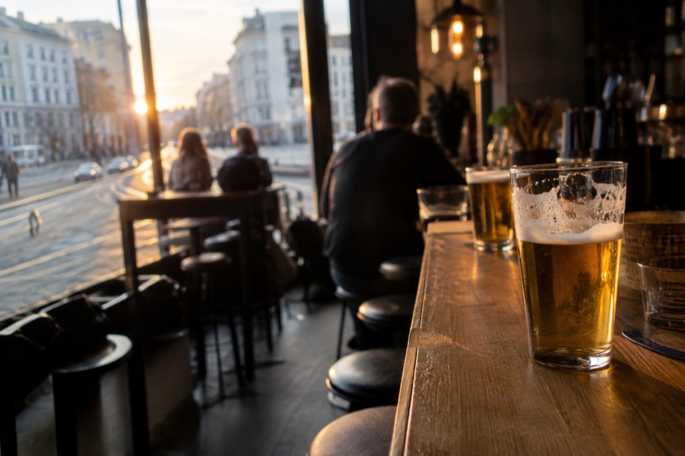 Beer glasses on a wooden bar counter in an Oslo bar