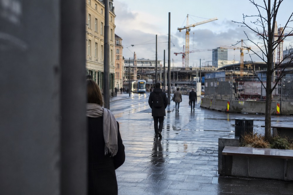 Construction barriers and cranes visible beyond the eastern platforms of Oslo Central Station