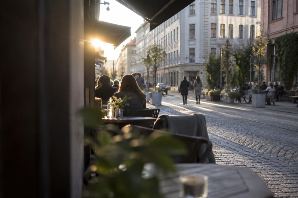 Cafe tables along a cobblestone street in the Grünerløkka district of Oslo