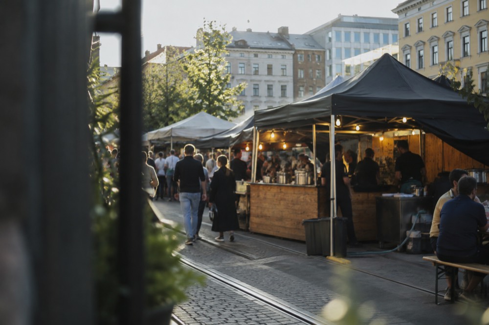 A street food market in Oslo with card terminal signs at the stalls