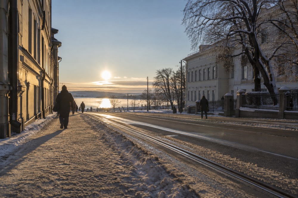 Low winter sun over the Oslofjord with long shadows on a frozen shoreline