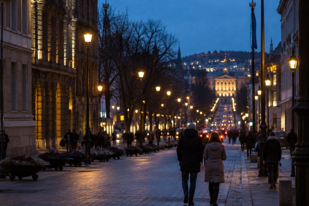 City lights coming on at dusk over Karl Johans gate with the sky still deep blue