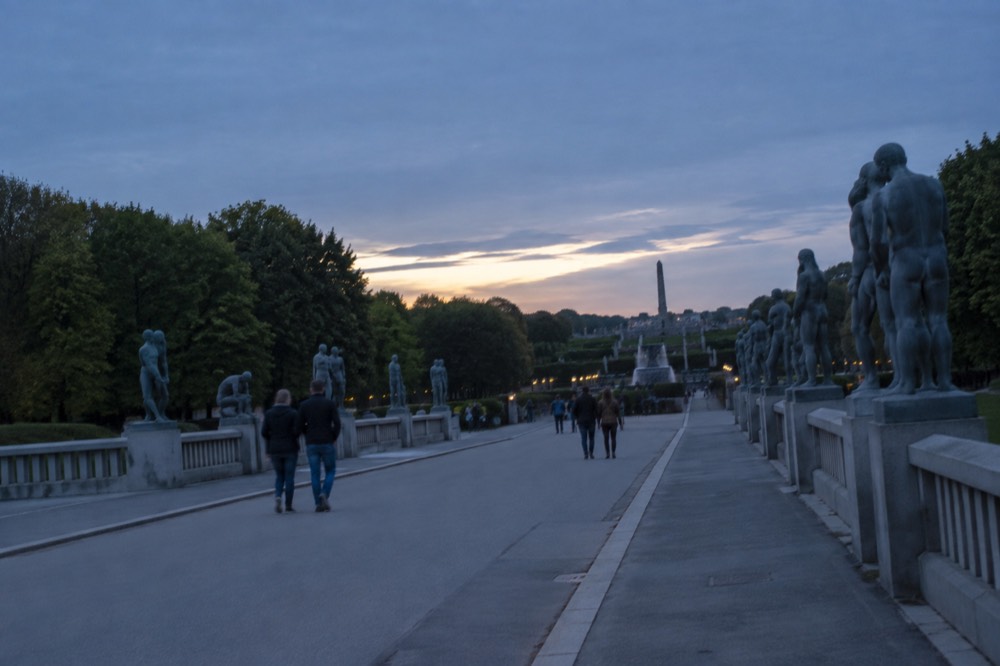 Granite sculptures arranged along a tree-lined path in the Vigeland sculpture park in Oslo