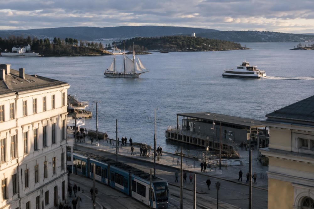 A wooden sailing ship and a modern ferry passing each other on the Oslofjord