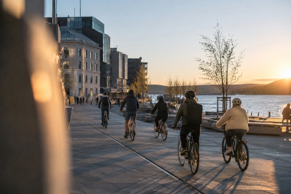 Cyclists on a guided bike tour riding along the Oslo waterfront