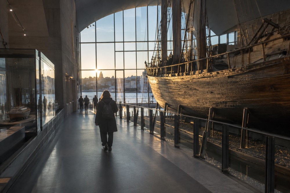 Wooden polar expedition ship displayed inside a museum hall