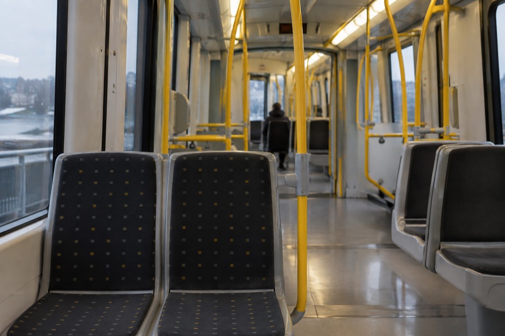 The interior of a modern Oslo metro train with empty seats and bright lighting