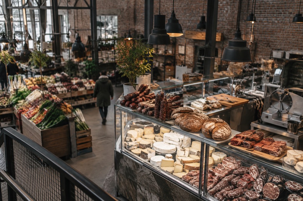 Food hall counter with cured meats, breads and cheeses on display