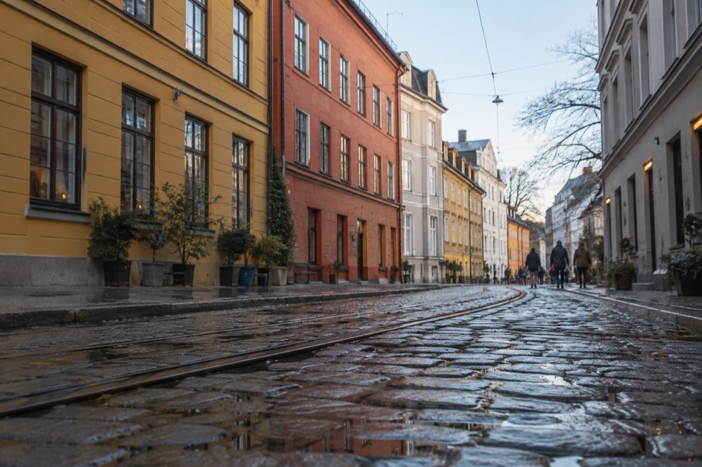Cobblestone street with colorful historic buildings in central Oslo