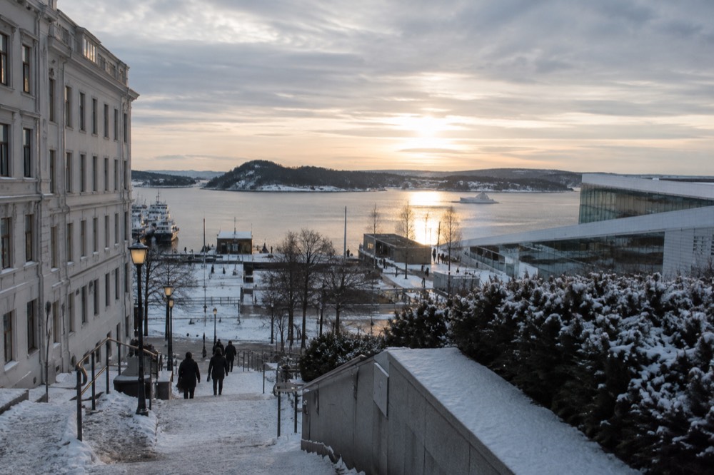 Low winter sun over the Oslofjord with long shadows on a snow-dusted waterfront