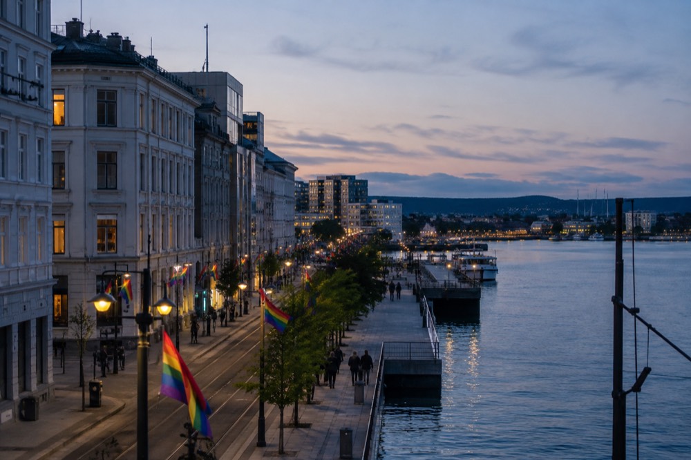 Rainbow flags flying along a waterfront street in central Oslo