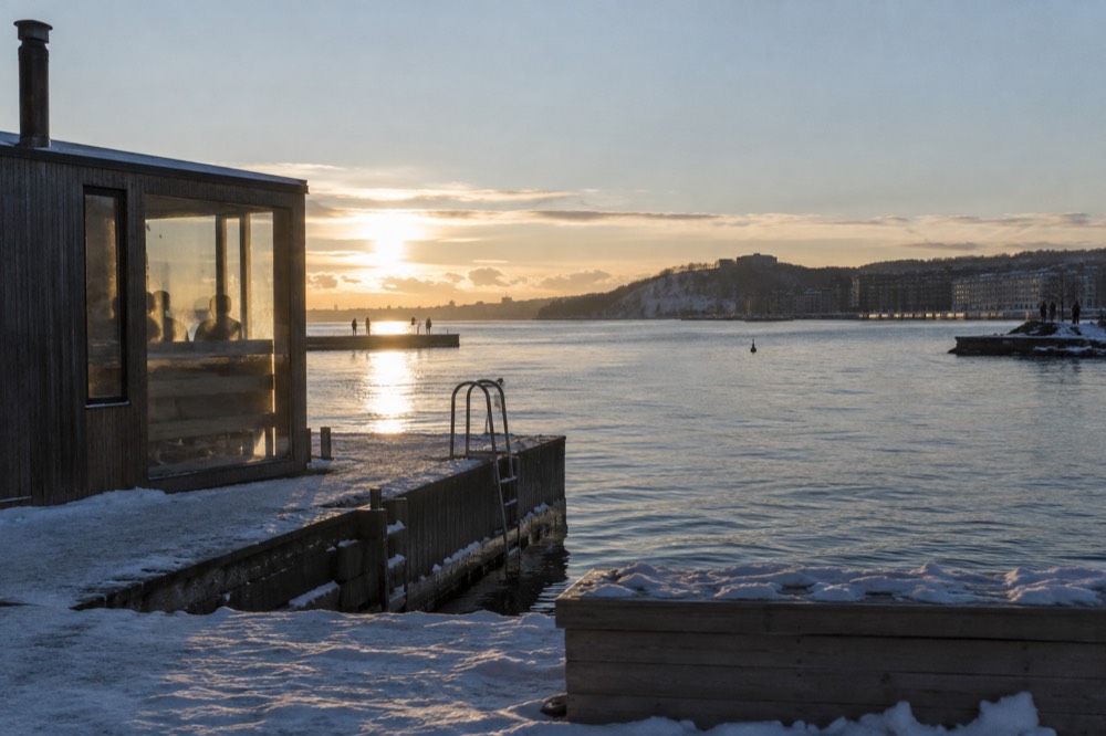 Wooden sauna cabin at the edge of the Oslofjord on a calm winter evening