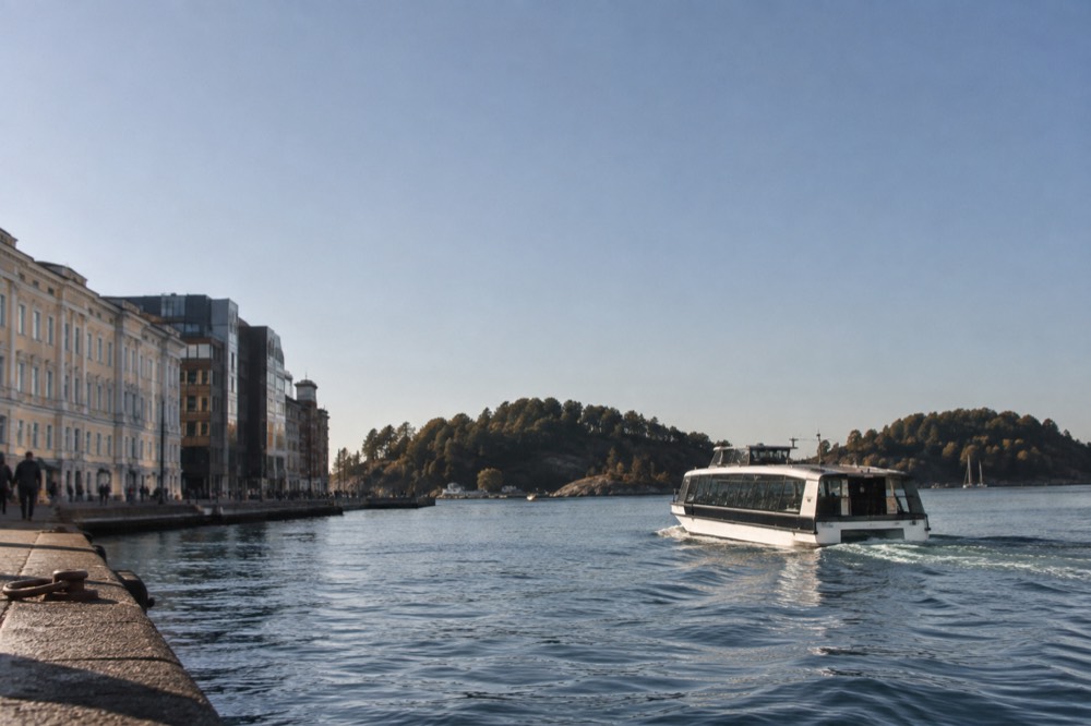 Electric sightseeing boat gliding on the Oslofjord past wooded islands