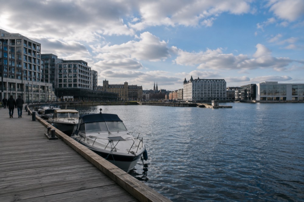 Harbour front with small boats moored along a wooden pier