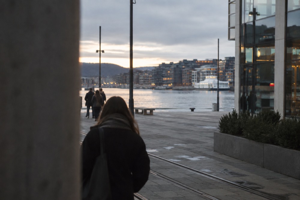 City waterfront at dusk with glass building facades reflecting light