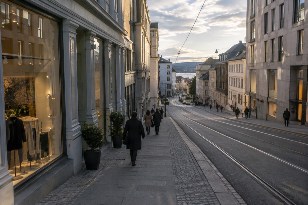Shopfronts on a European city street in soft evening light