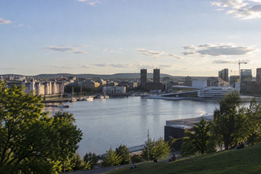 Oslo city skyline under a summer sky with the Oslofjord in the foreground