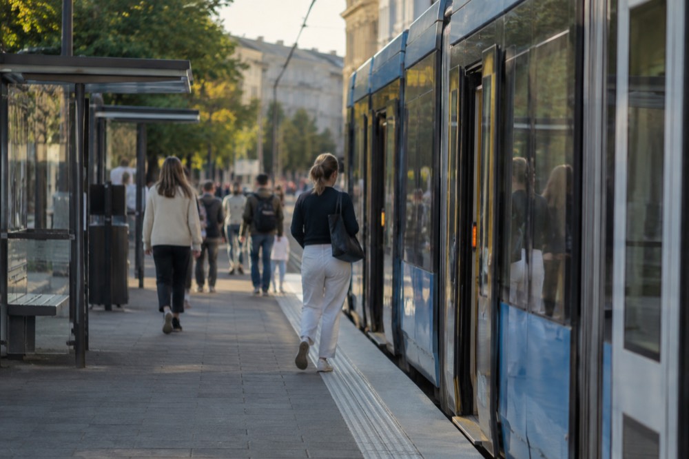 A tram stop with a level boarding platform and an open tram door