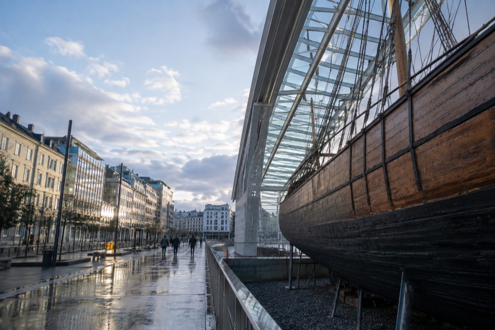 A wooden museum ship hull inside a bright exhibition hall