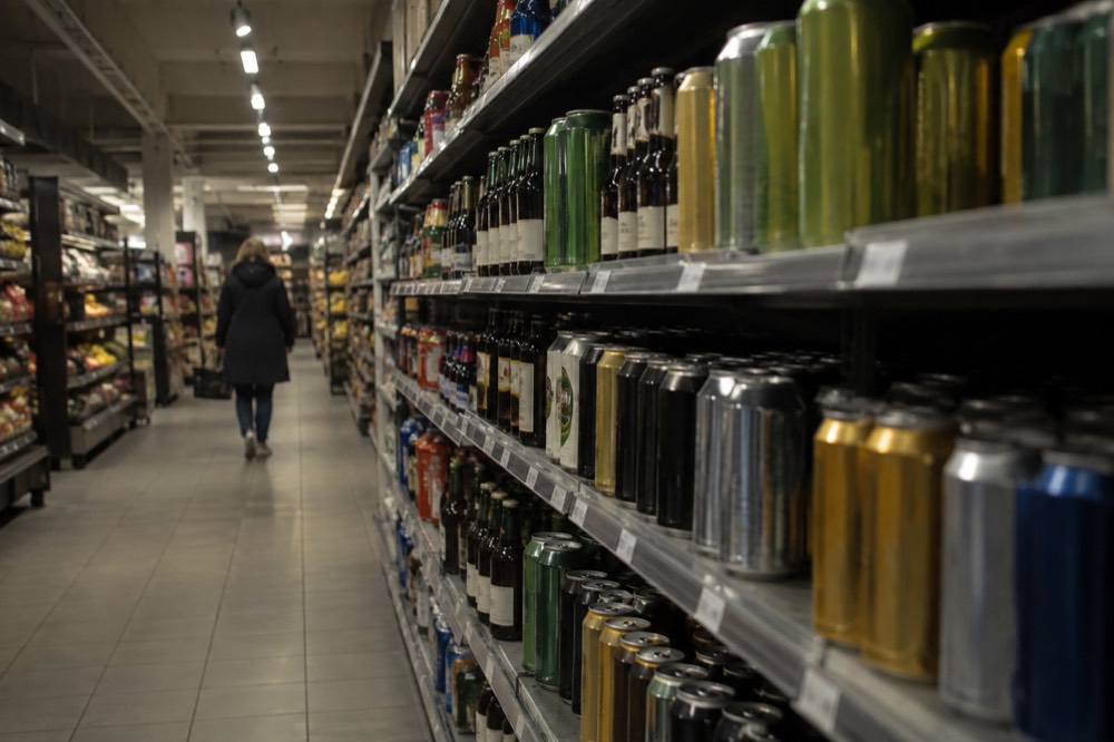 A supermarket shelf stocked with cans and bottles of beer in Norway