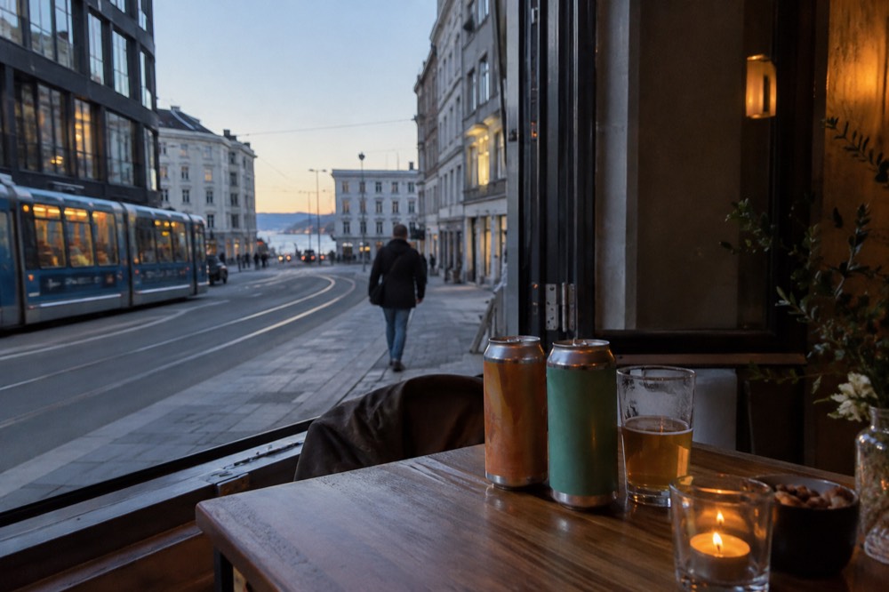 Cans of Norwegian craft beer on a wooden table beside an open window
