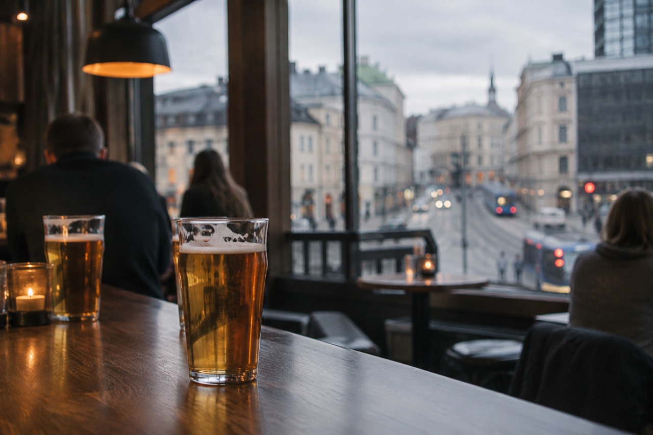 Glasses of beer on a wooden bar counter in an Oslo pub