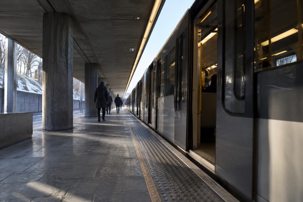 A metro platform in Oslo with a train waiting at the platform