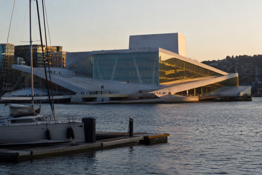 Oslo Opera House waterfront with moored boats and calm fjord water