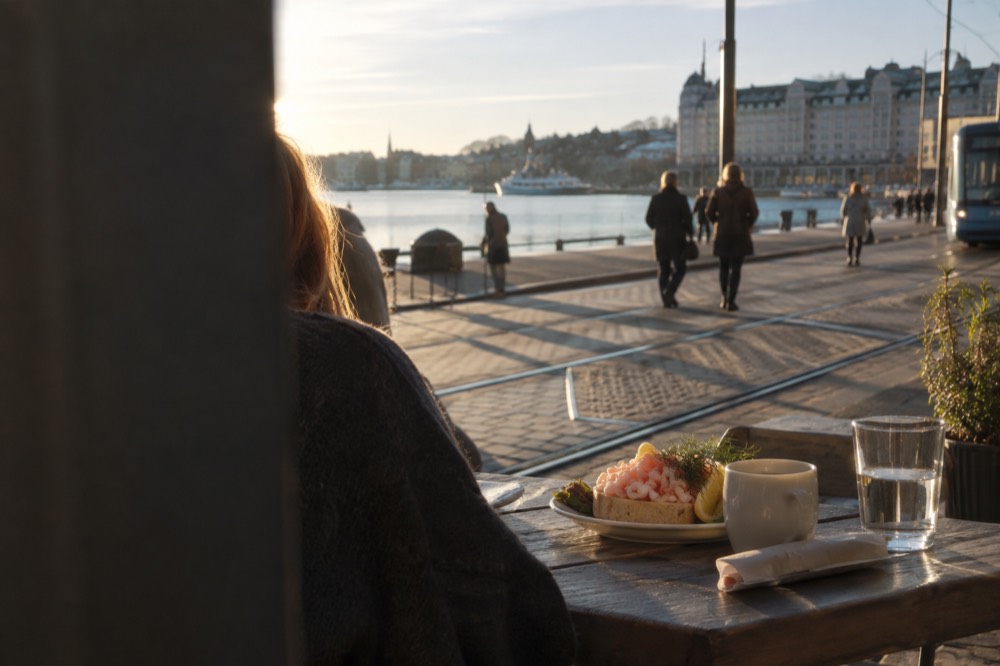 Fresh shrimp on bread served at a wooden table by the water