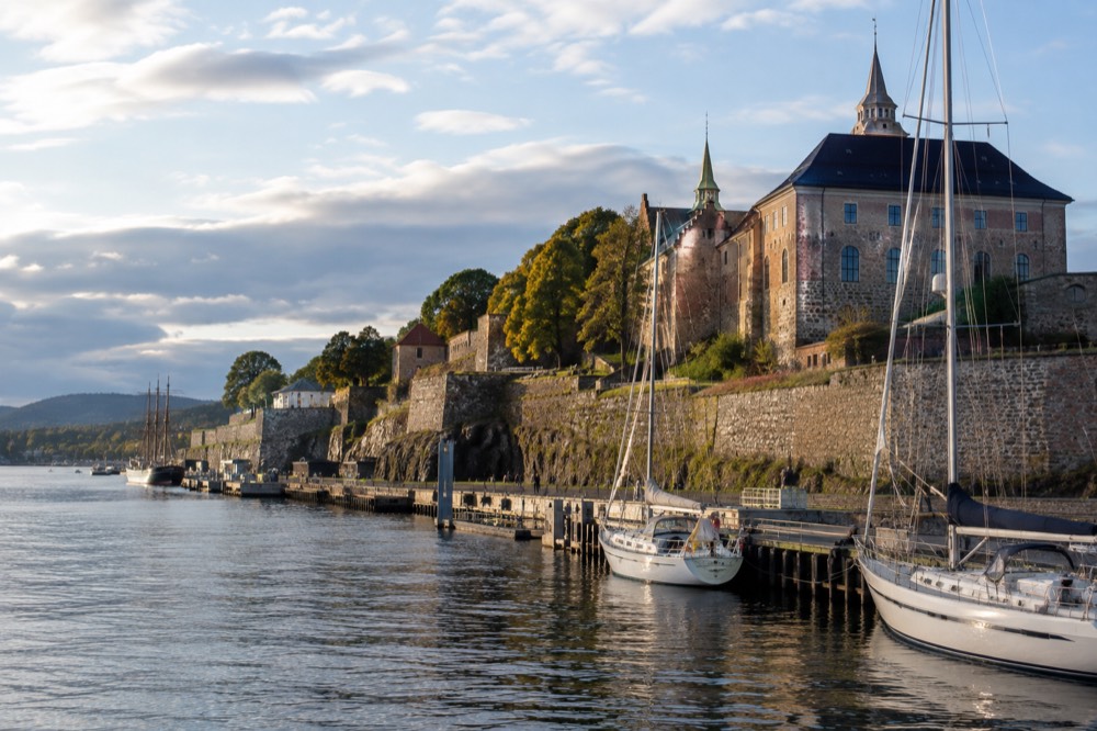 Akershus Fortress stone walls above the Oslofjord with moored sailboats