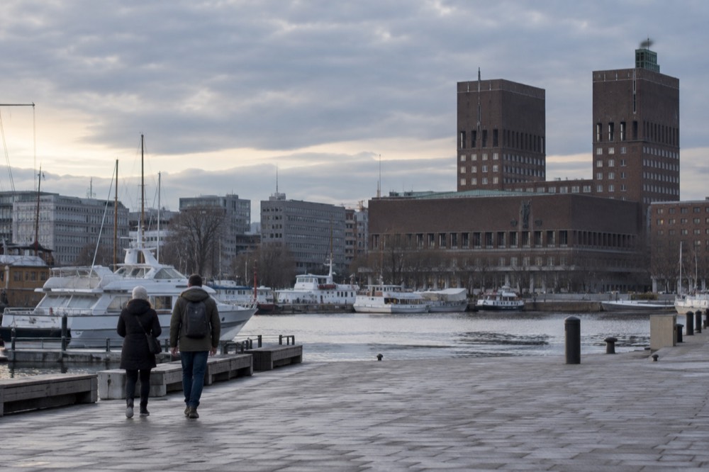 Oslo harbor with City Hall and moored boats in morning light