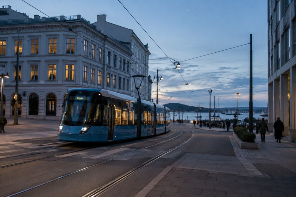 Tram crossing a central Oslo street near the harbor