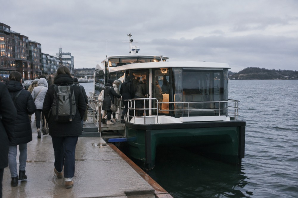 Passengers boarding a small electric fjord boat at the Oslo waterfront